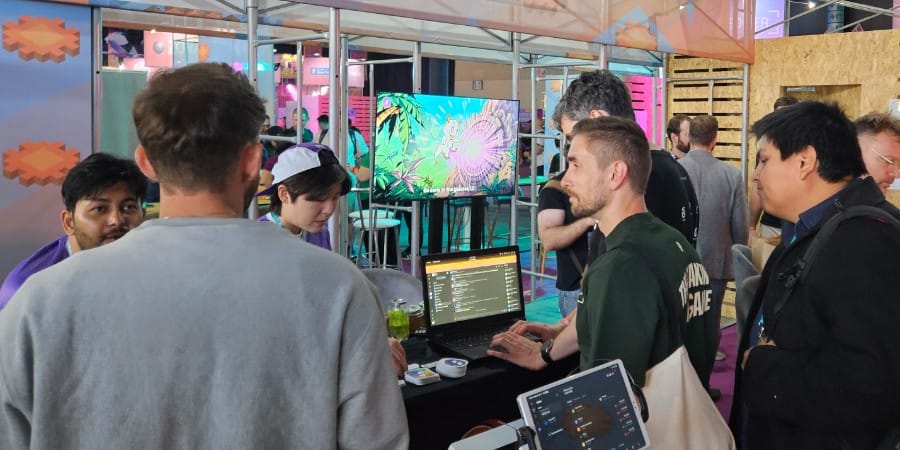 Status Network team talking with builders at the Devconnect World’s Fair booth about gasless transactions and user experience