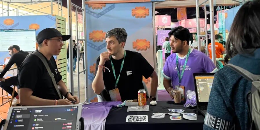 Visitors exploring Status Network demos at the Devconnect World’s Fair booth during discussions on gasless and privacy-first design